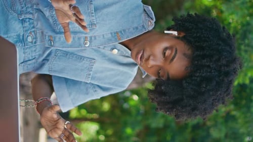 African Businesswoman Talking Video Meeting By Laptop in Park Close Up Vertical