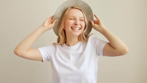 Cheerful Woman Posing with Hat and Smiling
