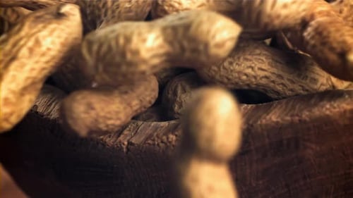 Peanuts Filling a Rustic Wooden Bowl