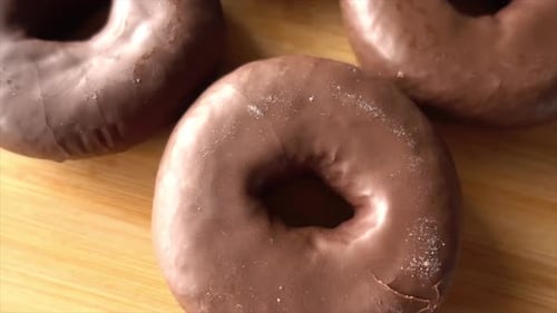 Chocolate Covered Donuts on a Wooden Surface