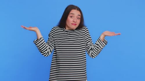 Young Woman Shrugs with Uncertainty