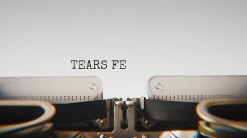 Old mechanical typewriter typing Tears Fell Without Sound in a close-up view.