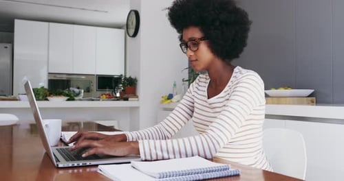 Woman Working on Laptop at Home, Daytime