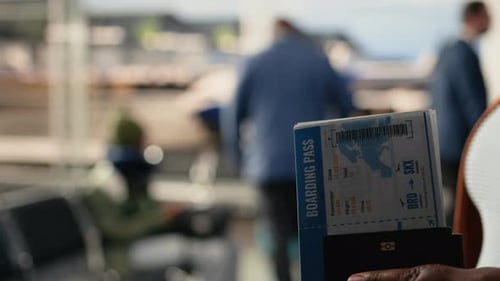 Plane Ticket and Passport Close Up Flight Details in Airport Departure Area
