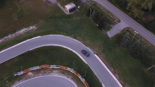 Aerial shot of sport car racing on real racetrack