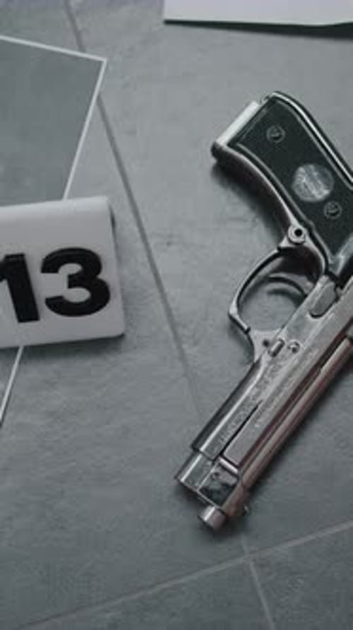 Top View on Murder Weapon Gun Lying Next to Numbered Marker