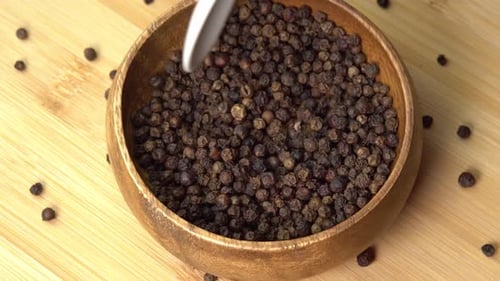 Black Peppercorns in Wooden Bowl with Spoon
