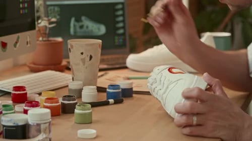 Artist Painting Bespoke Design on a Sneaker