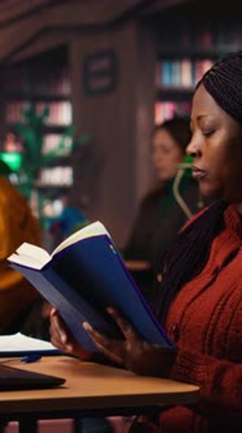 Woman Reading a Book in a Library