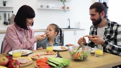 Loving Family Enjoying Pizza Meal Together at Home