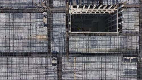 Aerial Video of Building Frame With Tower Crane in Background