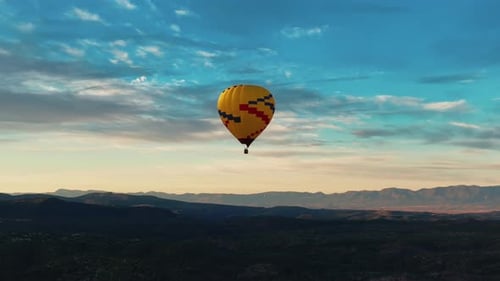 Colorful Hot Air Balloon Against Sky In Sedona, Arizona At Sunrise - drone shot