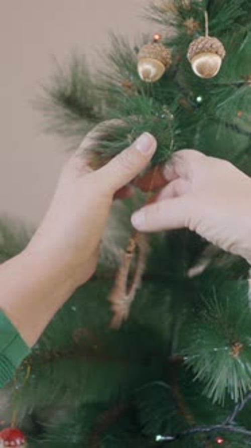 Decorating a Christmas Tree with Wooden Ornament