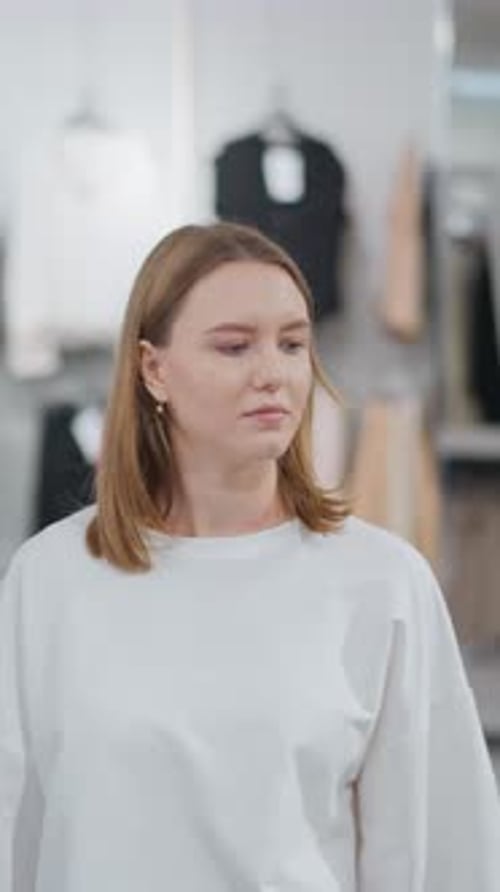 Woman Walking Through Clothing Store Looking Around