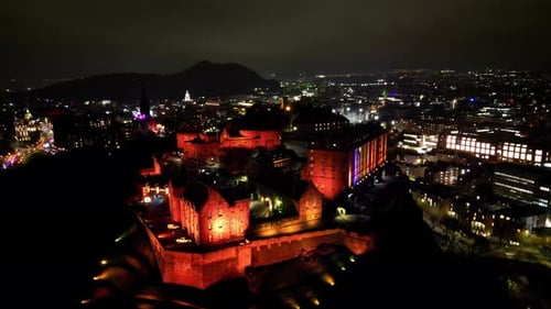 Edinburgh, Aerial view of the Edinburgh Castle on Castle Rock at night with the illuminated city on