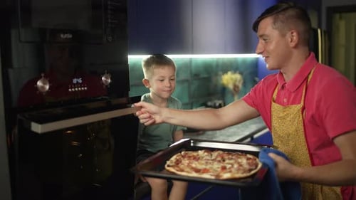 Father and Son Making Pizza Together at Home