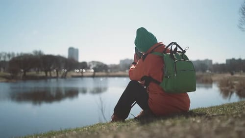 Woman Resting After Hiking in Park Sitting on Pond Shore Take Mobile Photo Active and Healthy