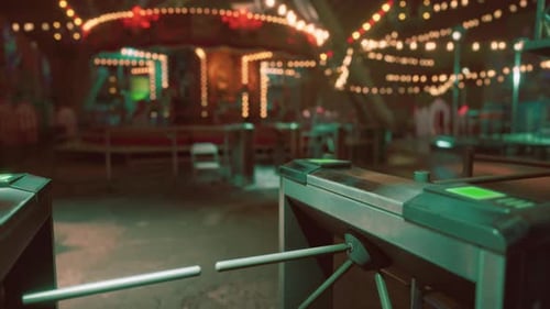 Empty Amusement Park with Closed Turnstiles During Nighttime Hours