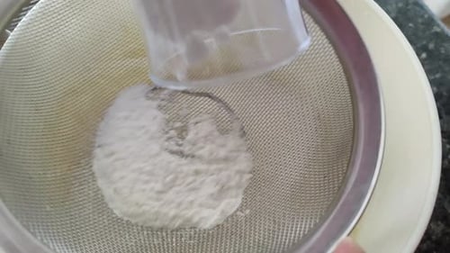 Sifting Flour into Bowl for Baking at Home