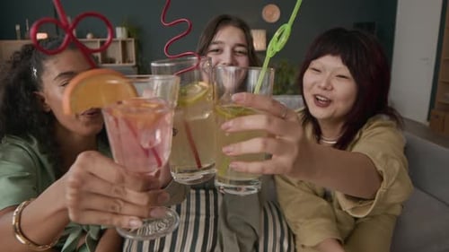 Happy Girlfriends Clinking Glasses Partying at Home