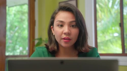 Young Short Hair Asian Woman Talking and Working on Computer Laptop at Home, Close-up Shot
