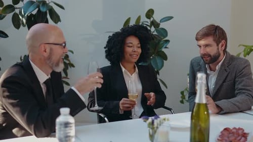 Colleagues Celebrating with Champagne in Office
