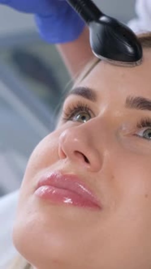 Woman Receives Facial Treatment at Clinic