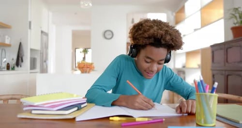 Boy Studying and Waving at the Camera