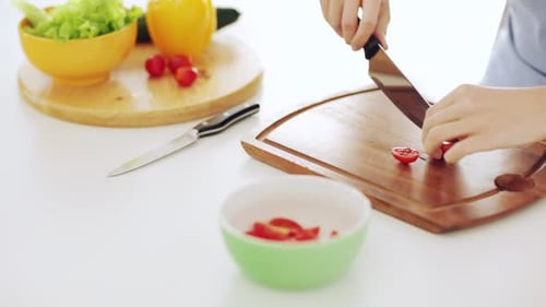 Woman Prepares Fresh Salad at Home in Kitchen