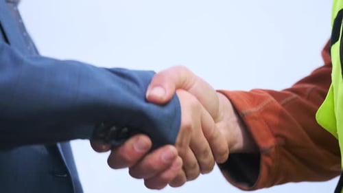 Close up handshake, businessman and man worker hands shakes, unrecognizable people in suit