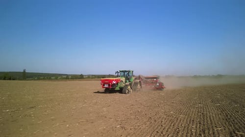 Tractor on the field seeding wheat