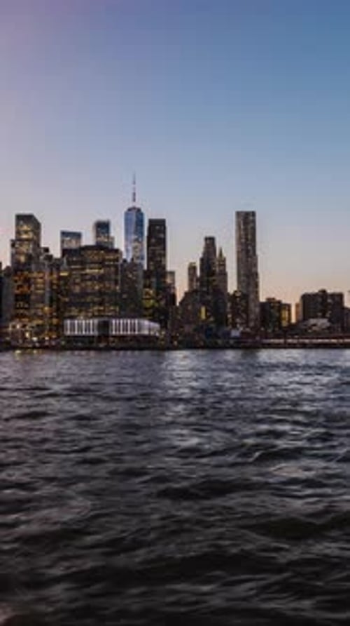 Vertical Timelapse with Panoramic Motion Showing New York Skyline and Brooklyn Bridge Transitioning