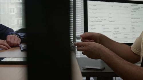 Man Filling out Documents at Government Office