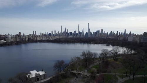 The Lake, Central Park, NYC, aerial view, sunny Manhattan skyline view in background during bright s