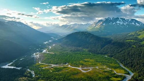 Approaching the spectacular valley crossed by the wavy river among the gorgeous mountains.