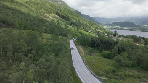 Motor Home And Bus Driving On The Mountain Road With Ardalsfjorden in Ardal, Vestland, Norway. - aer