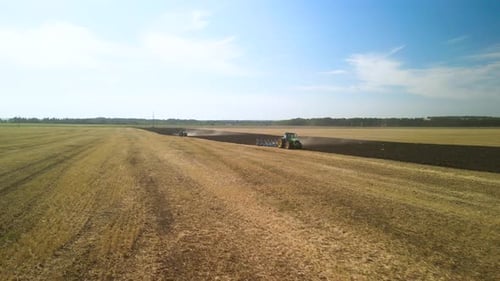 Tractors plowing the field in Ukraine