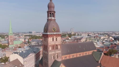 Drone aerial circling the bell tower on Riga Cathedral in Latvia on a summer day