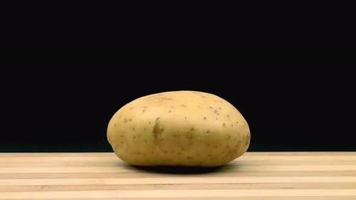 Whirling potato is chopped. Stop motion animation.