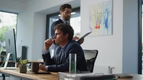 Focused Man Looking Monitor at Office Closeup Businessman Consulting Colleague