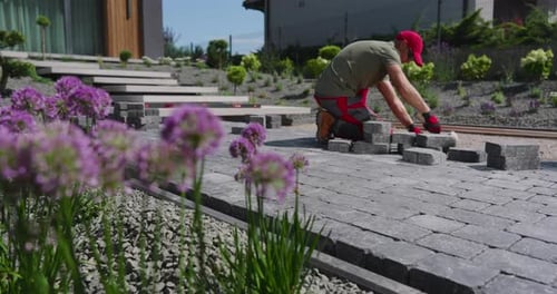 Laying Pavers in a Beautiful Garden Landscape in Spring