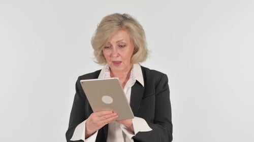 Senior Woman Interacts with Tablet Device