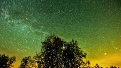 Night sky filled with trails of stars that form a mesmerizing and dramatic view