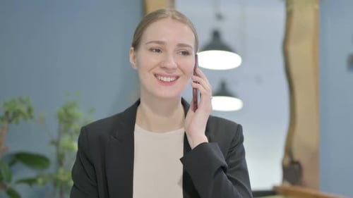 Smiling Woman Talking on Modern Mobile Phone