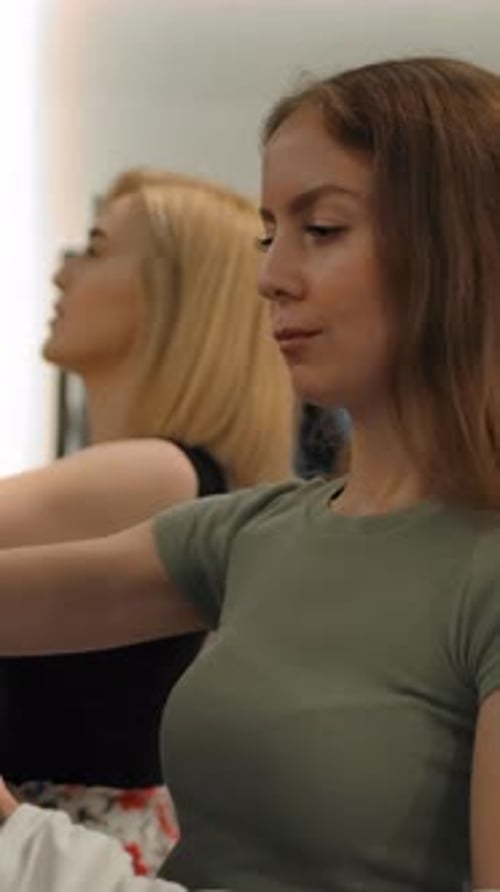 Vertical of Two Women Friends Choosing Clothes in a Clothing Store