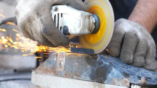 Detail View on Metal Processing with Circular Saw and Sparks Flying Around