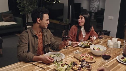 Friends Enjoying Dinner and Wine Together at Home