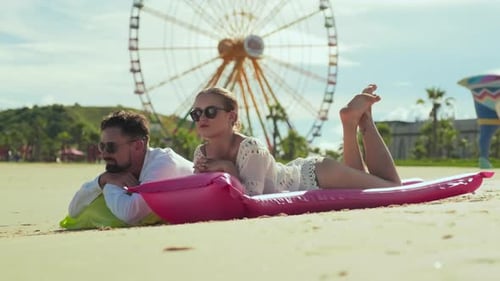 Young Couple Relaxing on Tropical Beach on Sunny Day and Talking