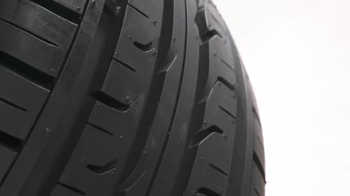 Tire Slowly Spinning On White Background
