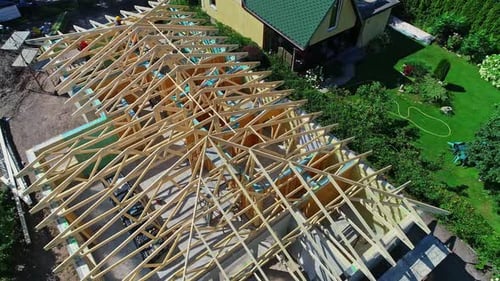 Construction Crew Builds Wooden Frame of New Home